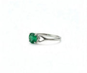 Emerald and gold ring that radiates timeless elegance with a vibrant green gemstone centerpiece